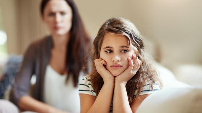 Cropped shot of a young girl being reprimanded by her mother at home