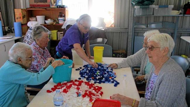 SORT IT OUT: Residents of Murroona Gardens have got behind the movement and are helping sort lids into colours.