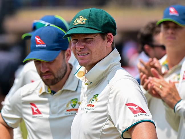 Australia's captain Steve Smith (C) along with his teammates, stands during the presentation ceremony at the end of the second Test cricket match between Sri Lanka and Australia at the Galle International Cricket Stadium in Galle on February 9, 2025. Australia won the second Test against Sri Lanka by nine wickets in Galle on February 9, to sweep the series 2-0. (Photo by Ishara S. KODIKARA / AFP)