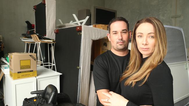 A pregnant Blanche Manby and her partner Chris Murray outside their storage shed where they've had to move all their possessions because they can't get a rental property. Their bank pulled finance at the last minute and now they have nowhere to go like hundreds of other Gold Coasters. Picture Glenn Hampson