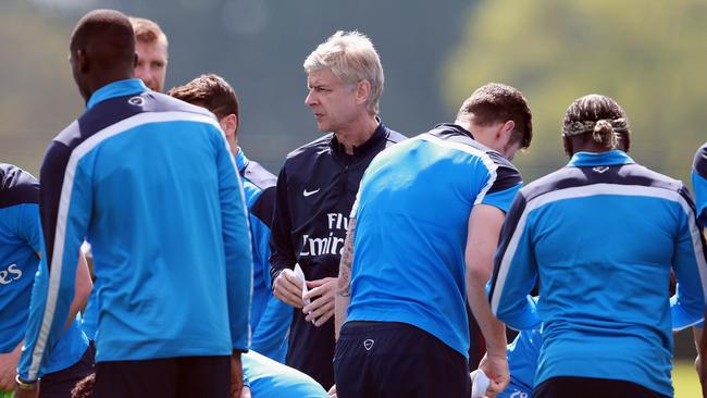 Arsenal manager Arsene Wenger, centre, pauses, during a training session with his team.