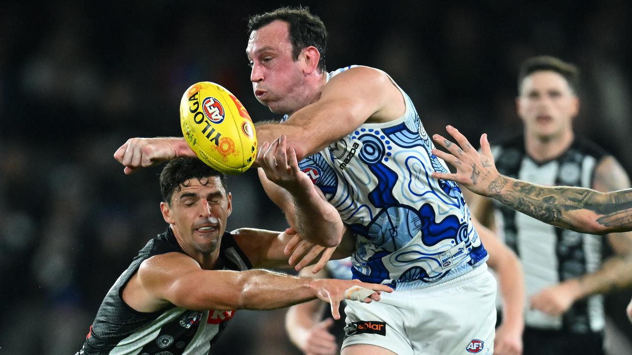 Todd Goldstein of the Kangaroos handballs whilst being tackled by Scott Pendlebury of the Magpies during the round 11 AFL match between Collingwood Magpies and North Melbourne Kangaroos at Marvel Stadium, on May 28, 2023, in Melbourne, Australia. (Photo by Quinn Rooney/Getty Images)