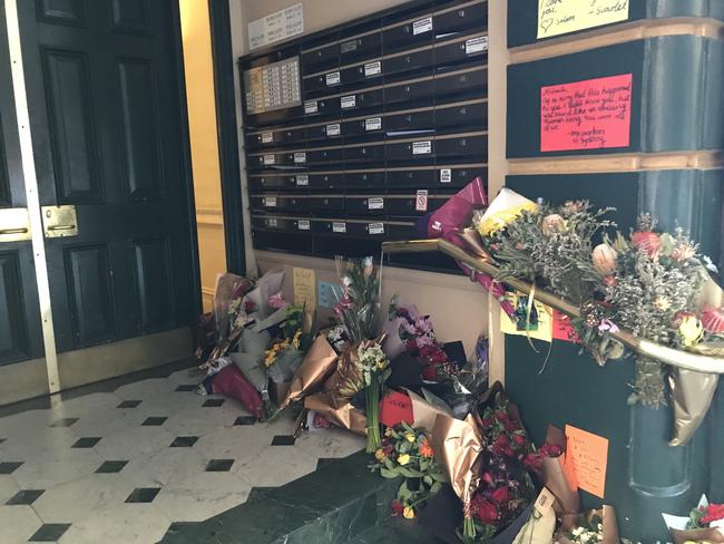 Flowers and handwritten notes left at Ms Dunn’s Clarence St apartment.