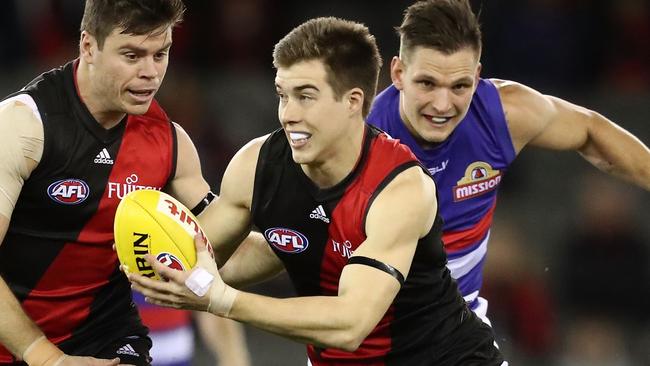 MELBOURNE, AUSTRALIA - AUGUST 21: Zach Merrett of the Bombers runs with the ball during the round 22 AFL match between the Essendon Bombers and the Western Bulldogs at Etihad Stadium on August 21, 2016 in Melbourne, Australia. (Photo by Scott Barbour/Getty Images)