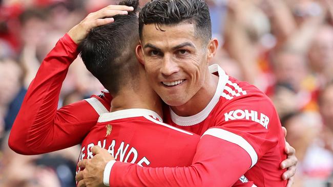 MANCHESTER, ENGLAND - SEPTEMBER 11: Bruno Fernandes of Manchester United celebrates with Cristiano Ronaldo after scoring their side's third goal during the Premier League match between Manchester United and Newcastle United at Old Trafford on September 11, 2021 in Manchester, England. (Photo by Clive Brunskill/Getty Images)