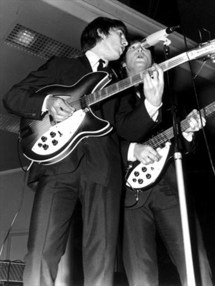 George Harrison and John Lennon performing at Festival Hall in 1964.