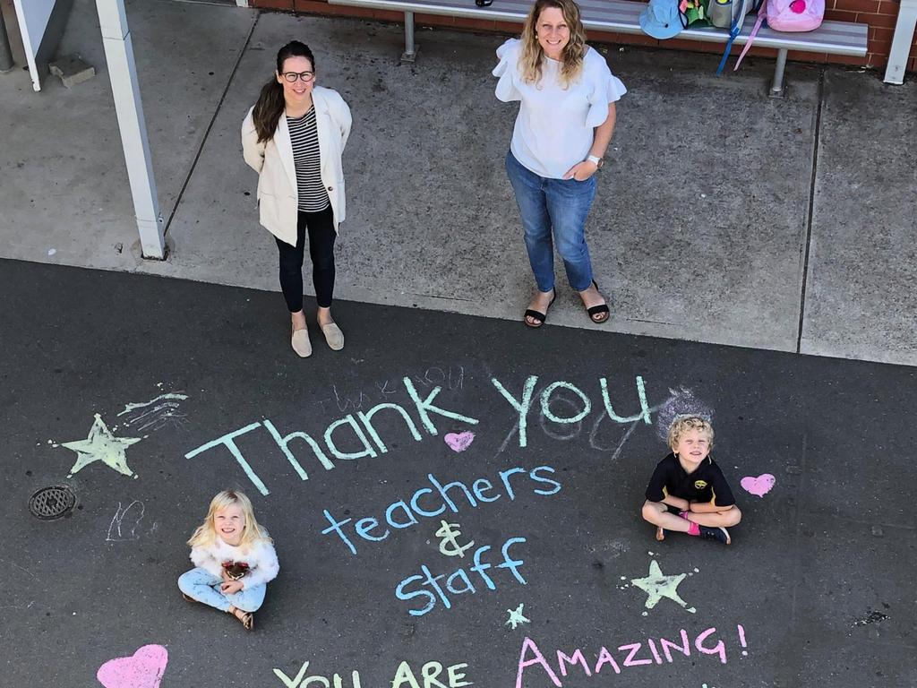 Allenby Gardens Primary School deputy principal El Mastrangelo with parent Fiona Weckert and children Elanora, 4, and Elijah, 6. Fiona and her children wrote this special message on the school grounds to surprise teachers and staff with on Monday morning (March 30). Picture: Supplied