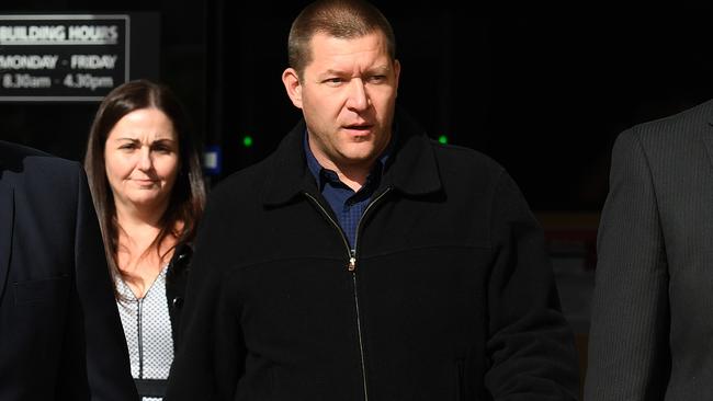 Thunder River Rapids ride operator Peter Nemeth (centre) leaves after giving evidence in the inquest into the Dreamworld disaster at the Magistrates Court at Southport. Picture: AAP Image/Dan Peled