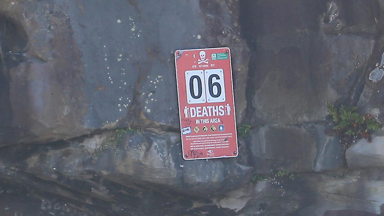 A sign at the north end of the beach advises the recent death toll at Little Bay. Picture: John Grainger