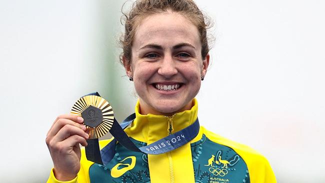 Australia's Grace Brown celebrates with her gold medal on the podium during the medal ceremony for the women's road cycling individual time trial during the Paris 2024 Olympic Games in Paris, on July 27, 2024. (Photo by Anne-Christine POUJOULAT / AFP)