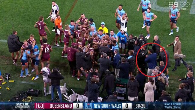 Haumole Olakau’atu was wearing a suit when he ran in and got involved in the melee. Picture: Channel 9