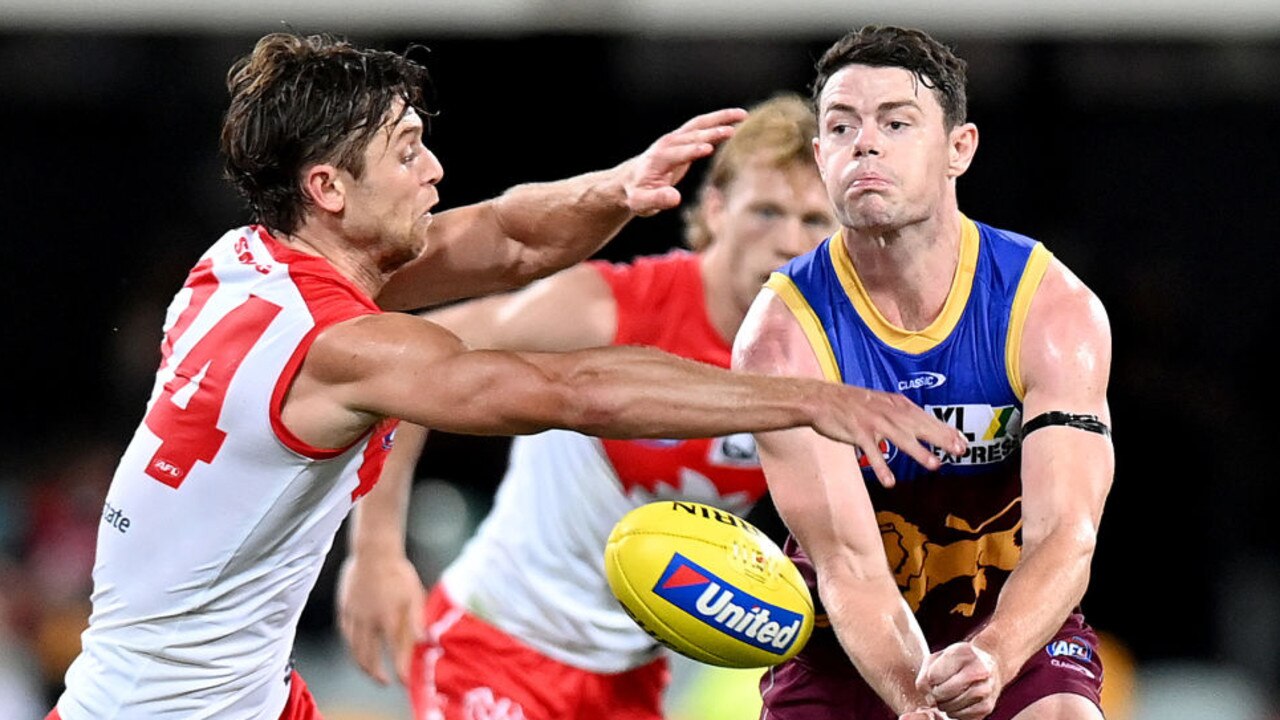 BRISBANE, AUSTRALIA - MARCH 20: Lachie Neale of the Lions handballs during the round one AFL match between the Brisbane Lions and the Sydney Swans at The Gabba on March 20, 2021 in Brisbane, Australia. (Photo by Bradley Kanaris/Getty Images)