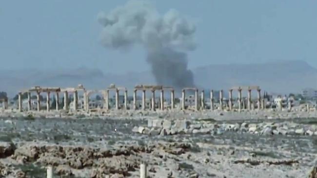 Smoke rises over the ancient ruins of Palmyra.