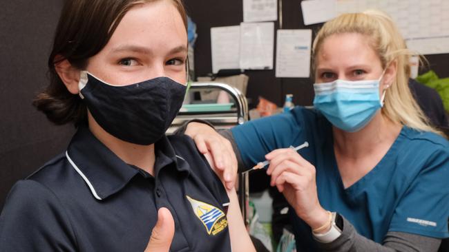 Bellarine Respiratory Clinic in Ocean Grove giving Covid vaccinations, with nurse immuniser Sarah Booth giving 12-year-old Oliver his jab Picture: Mark Wilson