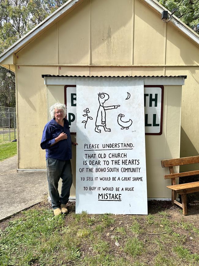 Cartoonist Michael Leunig with his cartoon in front of the Boho South Church Community Hall.