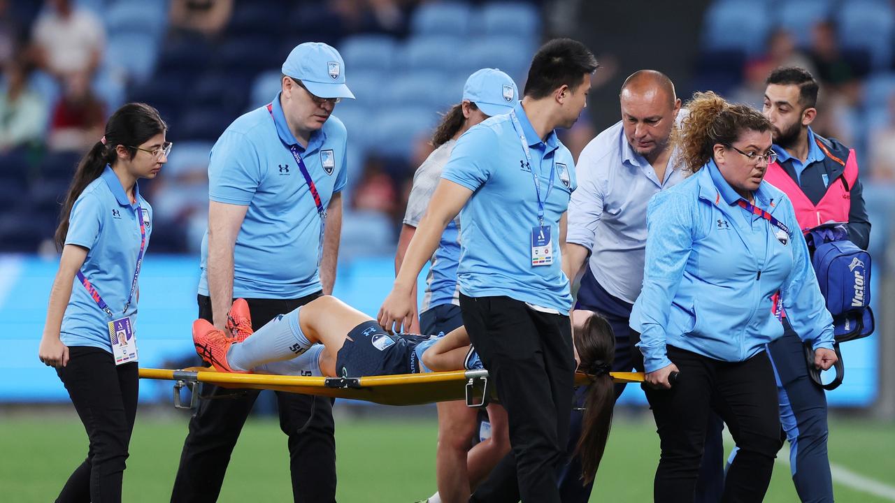 Sydney FC head coach Ante Juric consoles Natalie Tobin as she is stretchered from the field with an ACL injury. Picture: Mark Metcalfe/Getty Images