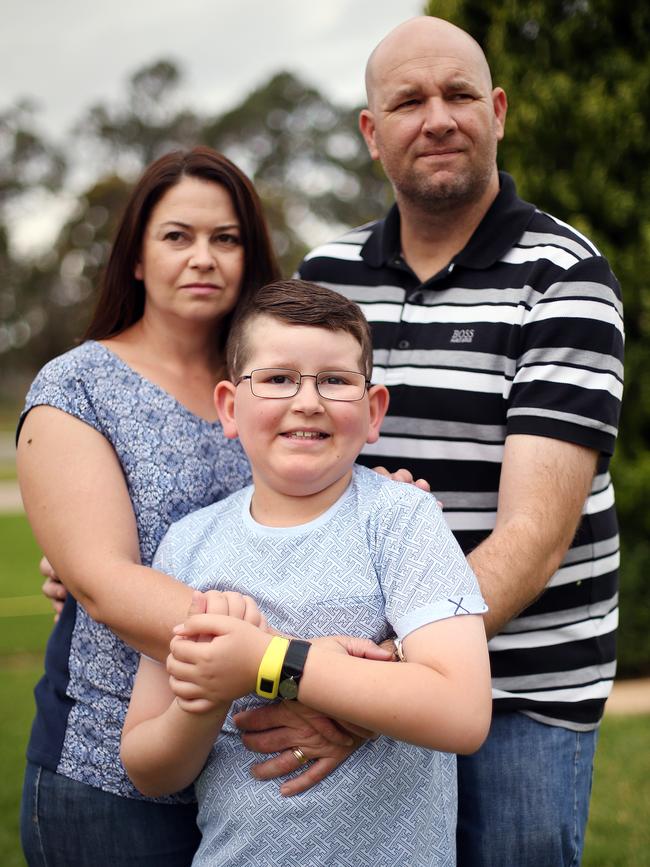 Josh with parents Emma and Glen Carter, who struggled to deal with the impact of his illness.