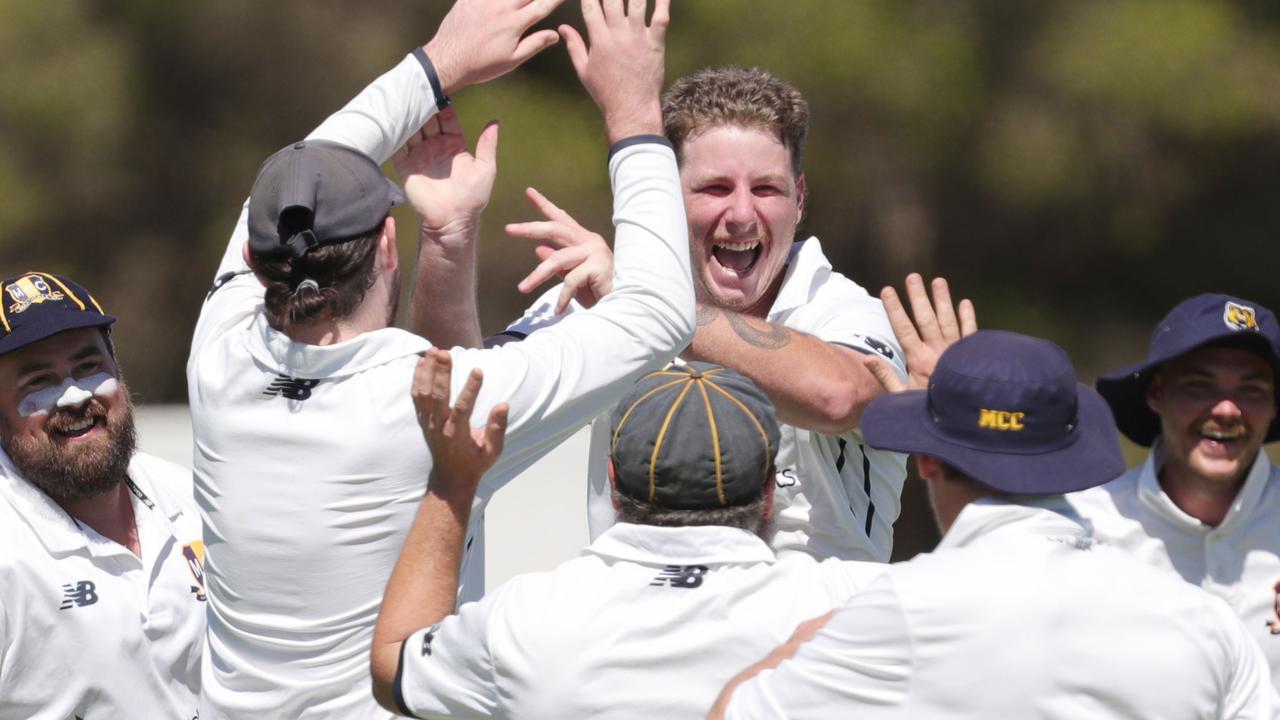 Marshall’s Blayke Sadler (middle) celebrates with teammates after taking one of his five wickets. Picture: Mark Wilson