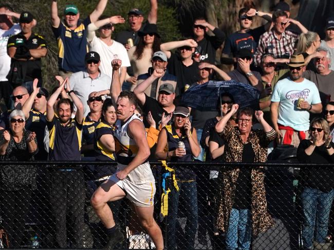 Adam Read celebrates a goal for the Eagles, to the delight of their supporters.