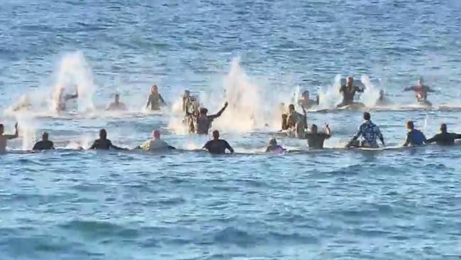 Channel 9 images of surfers going out to sea in memoriam of Kawa Sweeney. Picture: Channel 9.