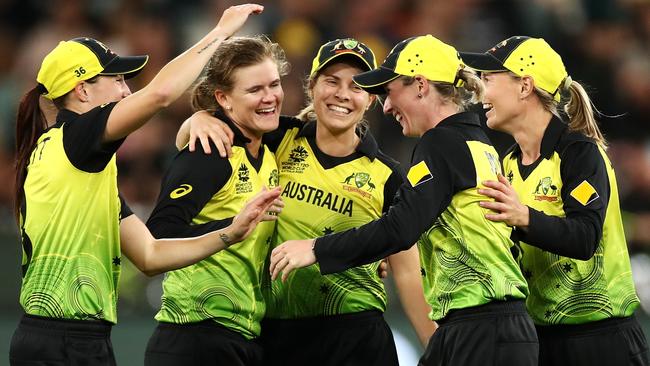 Australian women cricketers celebrate victory in the T20 Cricket World Cup final