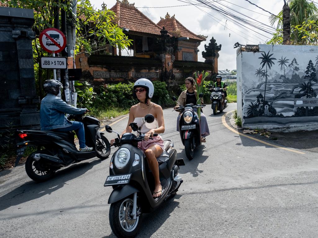 A foreigner tourist rides a motorcycle at a main road in Canggu, Bali, Indonesia. Picture: Getty Images