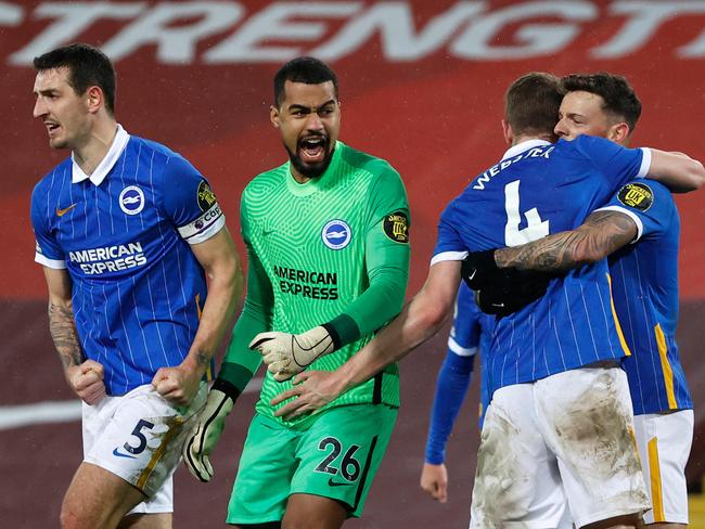 Brighton goalkeeper Robert Sanchez, celebrates with defenders Lewis Dunk and Adam Webster.