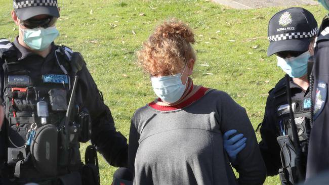 Police arrest a woman at the Shrine of Remembrance after refusing to wear a mask. Picture: NCA NewsWire /David Crosling