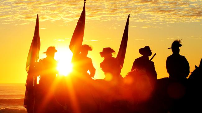 Members of the Light Horse Re-Enactment Group welcome the sunrise at the Anzac Day dawn service at Elephant Rock Currumbin. Pics Tim Marsden