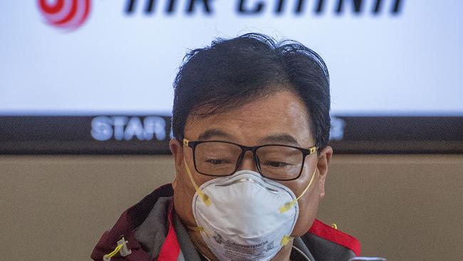 A Chinese citizen wears face masks to protect against the spread of the Coronavirus as he checks in to his Air China flight to Beijing, at Los Angeles International Airport, California, on February 2, 2020. (Photo by Mark RALSTON / AFP)