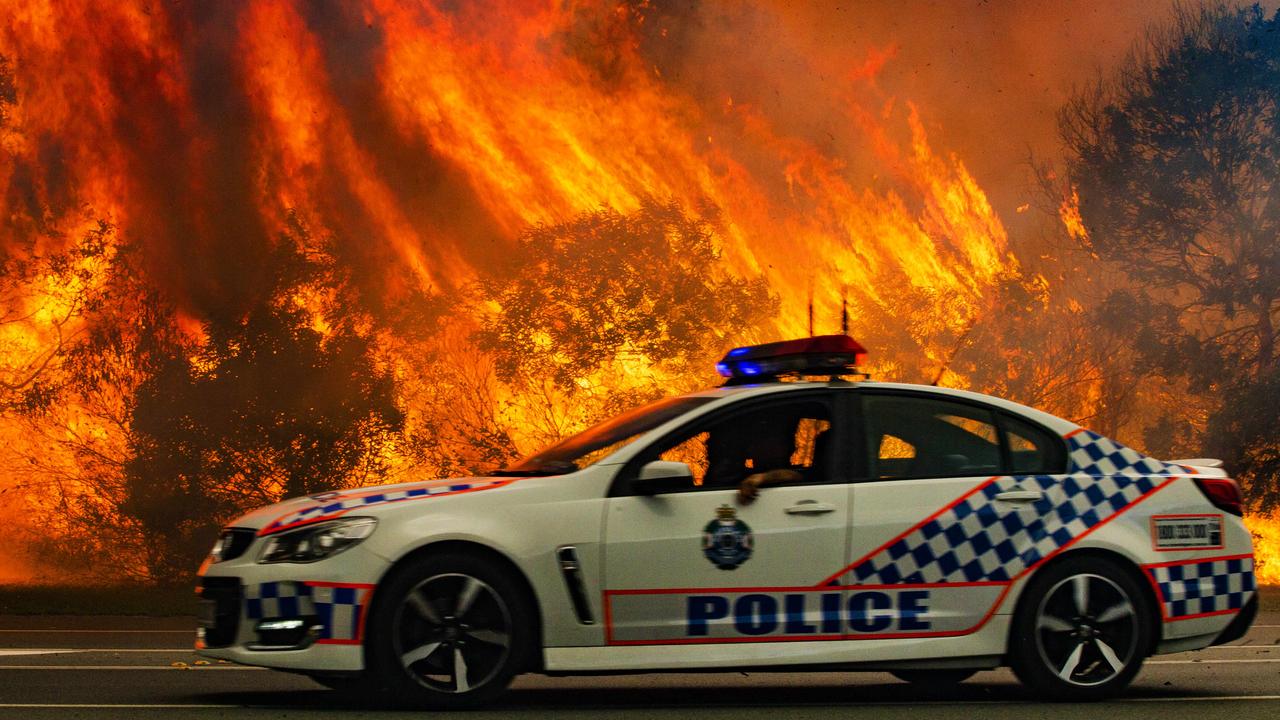 Police on the scene south of Peregian Beach as water bombing helicopters were called in to fight the wild bushfire. Photo Lachie Millard