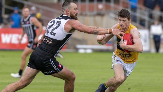 Eagle Luke Beecken evades the tackle of Port Adelaide’s Charlie Dixon at Alberton Oval on Saturday. Picture: Naomi Jellicoe.