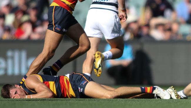 Jake Kelly lies on the ground concussed after his collision with Patrick Dangerfield.