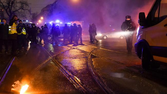 A flare thrown by protesters burns on the ground not far from Moscow's penal detention centre Number 1 where opposition leader Alexei Navalny is being held. Picture: Vasily Maximov/AFP