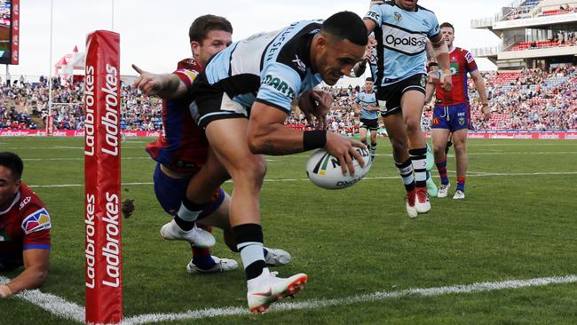 Valentine Holmes scored a hat-trick for the Sharks to boost his State of Origin hopes.