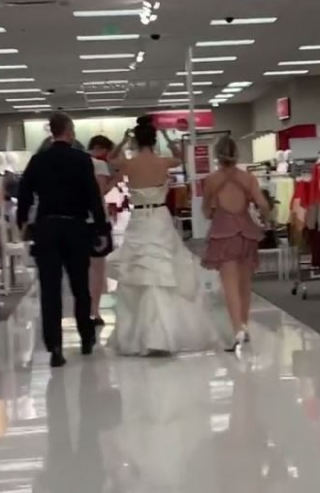 A bride wearing a full-length gown stormed through a Target store in Las Vegas, US, on the hunt for her fiance who works at the retail chain. Picture: TikTok/@boymom_ashley