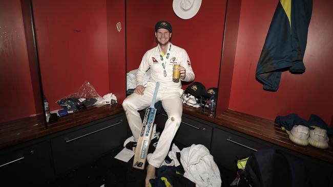 Steve Smith celebrates in the change rooms at Old Trafford.