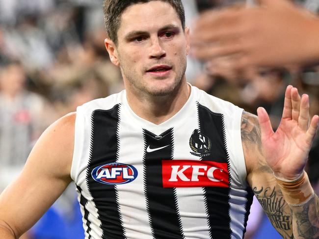 MELBOURNE, AUSTRALIA - MARCH 21: Jack Crisp of the Magpies high fives fans after winning the round two AFL match between Footscray Bulldogs (Western Bulldogs) and Collingwood Magpies at Melbourne Cricket Ground, on March 21, 2025, in Melbourne, Australia. (Photo by Quinn Rooney/Getty Images)