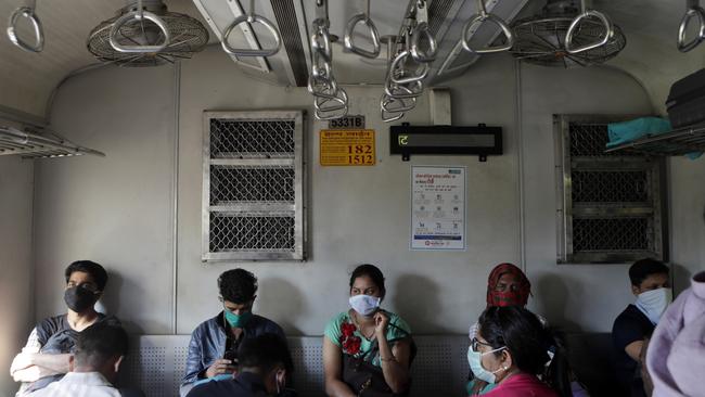 Commuters wear protective face masks in Mumbai. Picture: AP