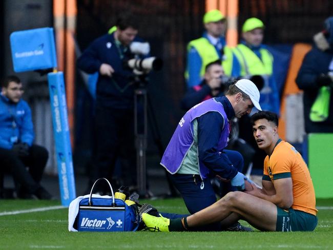 Joseph-Aukuso Suaalii receives medical treatment after sustaining an injury, before later leaving the field, in the loss to Scotland. Picture: Getty Images