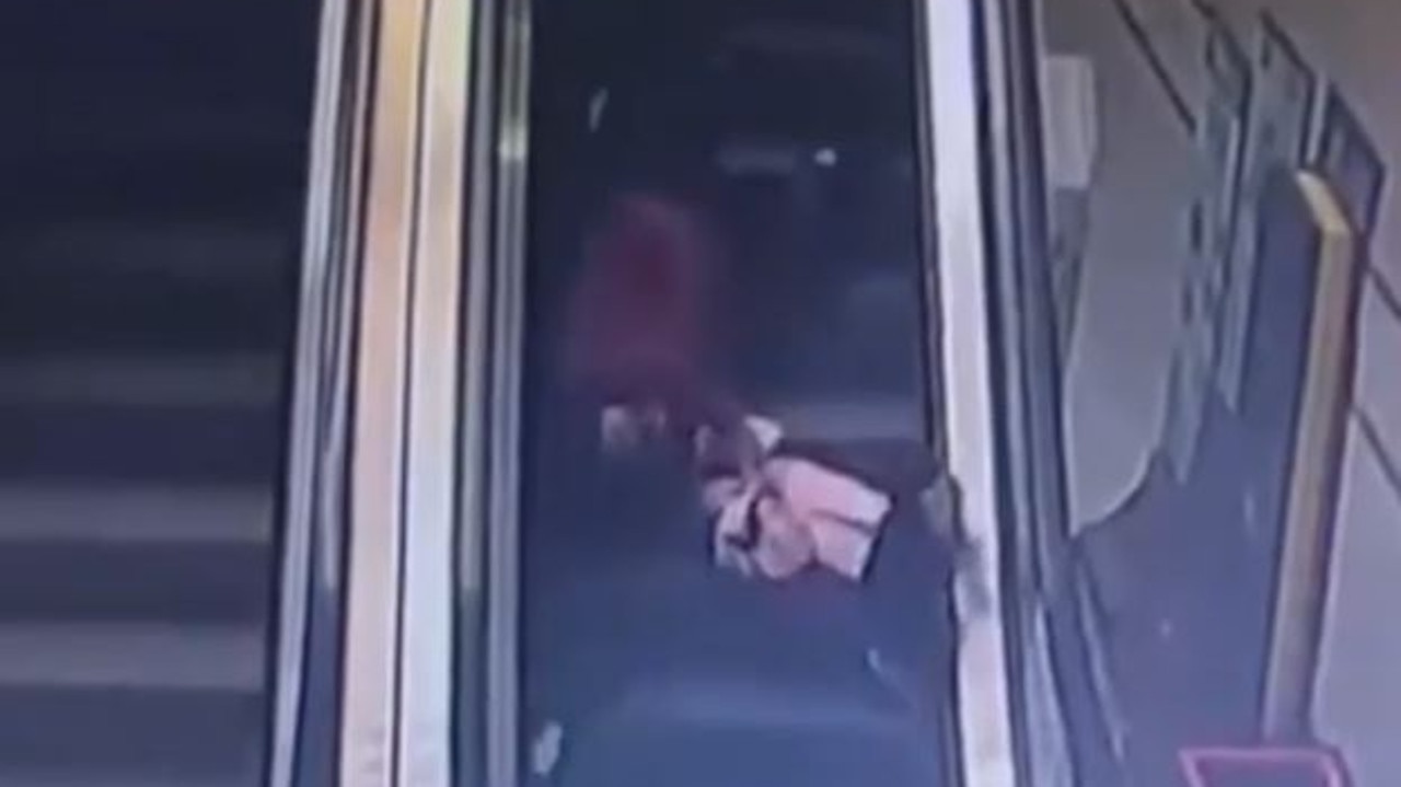 Woman falls, drags child down escalator