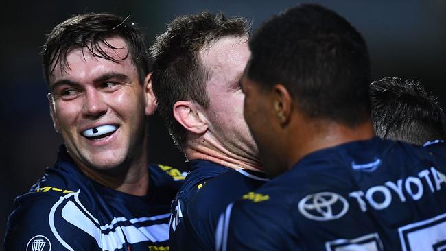 Cowboys players celebrate a try against the Titans.