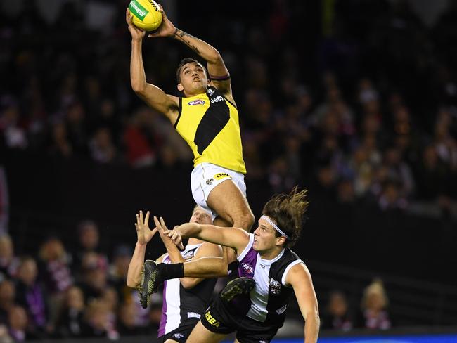 Sydney Stack of the Tigers marks during the Round 12 AFL match between the Richmond Tigers and the Geelong Cats at MCG in Melbourne, Friday, June 7, 2019. (AAP Image/Julian Smith) NO ARCHIVING, EDITORIAL USE ONLY