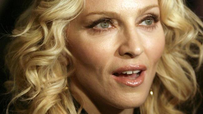 WIRE: US pop icon Madonna poses on the red carpet as she arrives for the premiere of the film she directed 