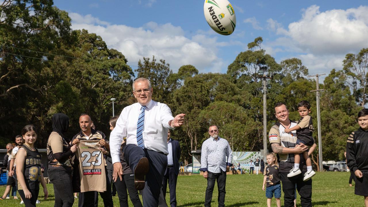 Scott Morrison displays his rugby skills on a visit to his own electorate in Sydney. Picture: Jason Edwards