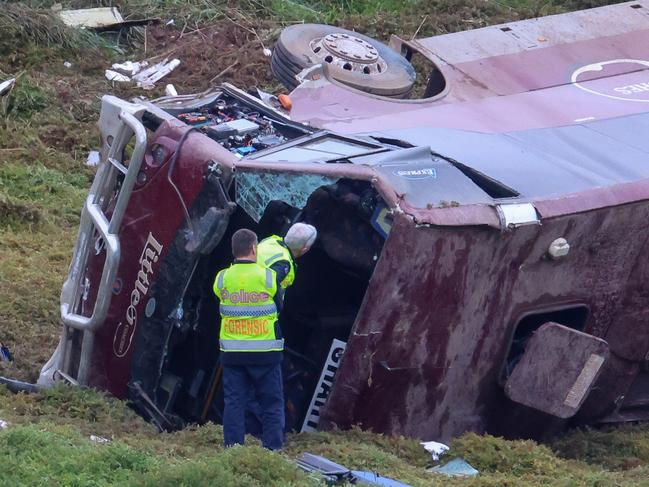 MELBOURNE, AUSTRALIA- SEPTEMBER 21 A school bus carrying 32 people has flipped on the Western Highway in Bacchus Marsh. Police are investigating the crash between a school bus and a truck that occured at around 3.15am. Picture: Brendan Beckett