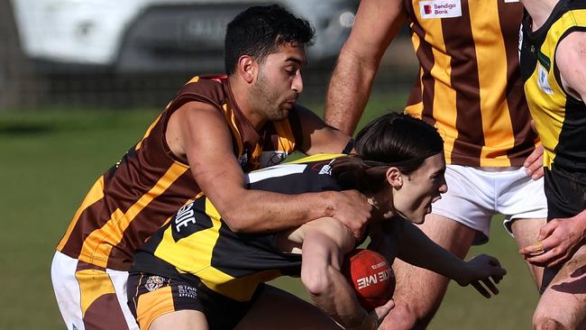 RDFNL: Lancefield’s Lachlan Giles is wrapped up by Kyle Baker of Woodend-Hesket. Photo: Hamish Blair