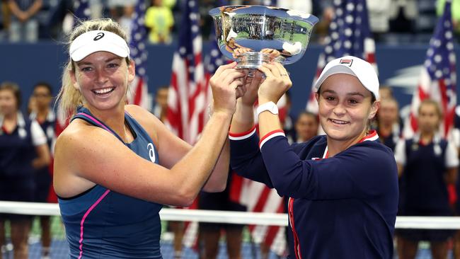 Coco Vandeweghe and Australia’s Ashleigh Barty pose with the championship trophy after winning the women's doubles final. Picture: Getty