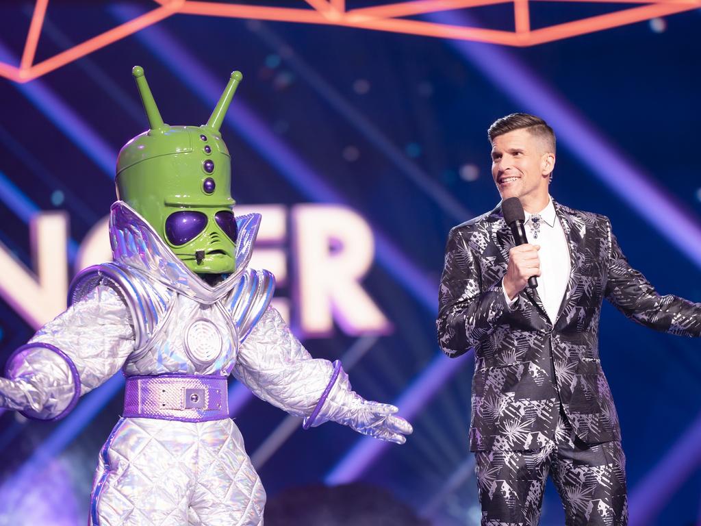 The Masked Singer host Osher Gunsberg with one of the show's mystery celebrity contestants. Supplied by Channel 10.