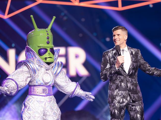 The Masked Singer host Osher Gunsberg with one of the show's mystery celebrity contestants. Supplied by Channel 10.